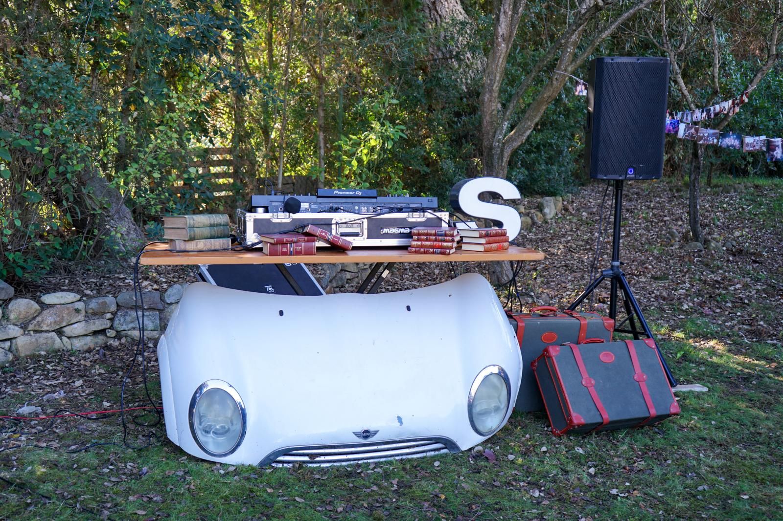 Vintage car-front DJ booth set up in a garden for a boho celebration