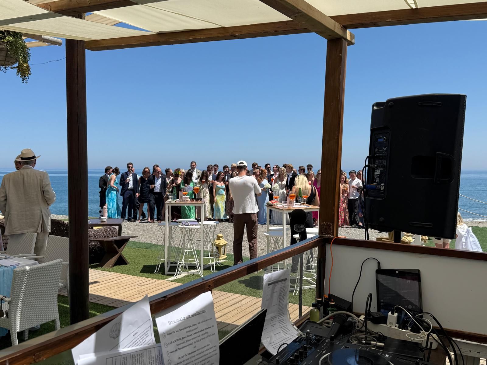 Sound system set up on a terrace overlooking the sea during a wedding