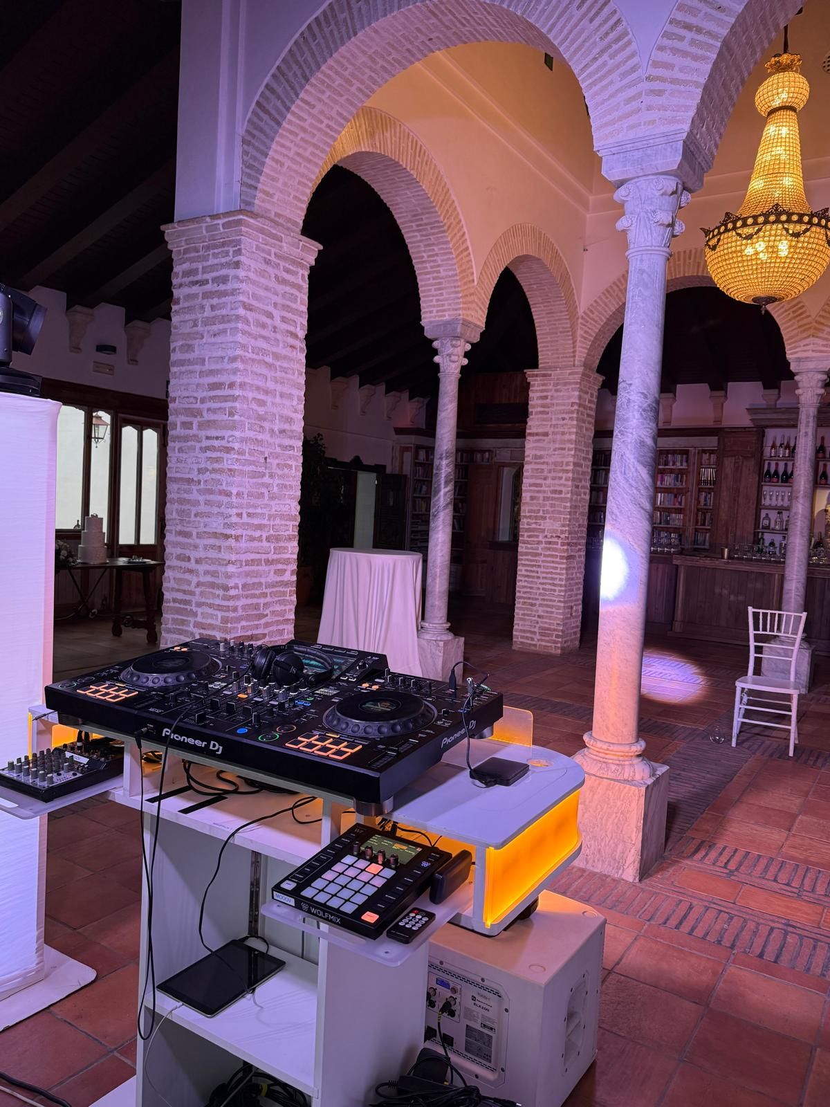 DJ setup between Moorish arches at an elegant venue