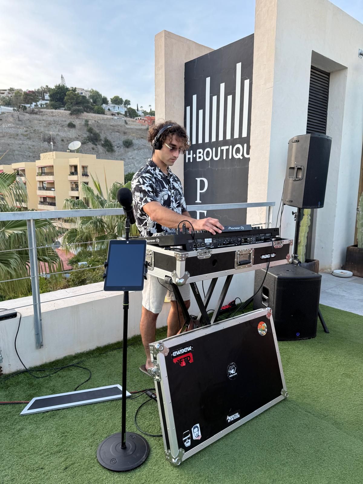 Sergio DJing on a rooftop terrace at a wedding
